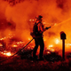 A Butte County firefighter douses flames at the Bear Fire in Oroville, California on September 9, 2020.